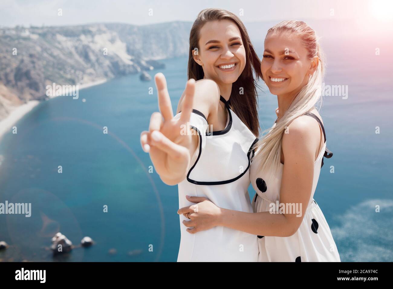 Portrait of a two beautiful young smiling woman outdoor at paradise ...