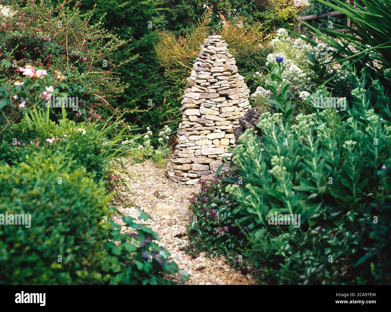 A Cotswold stone cairn makes a fine garden talking point Stock Photo