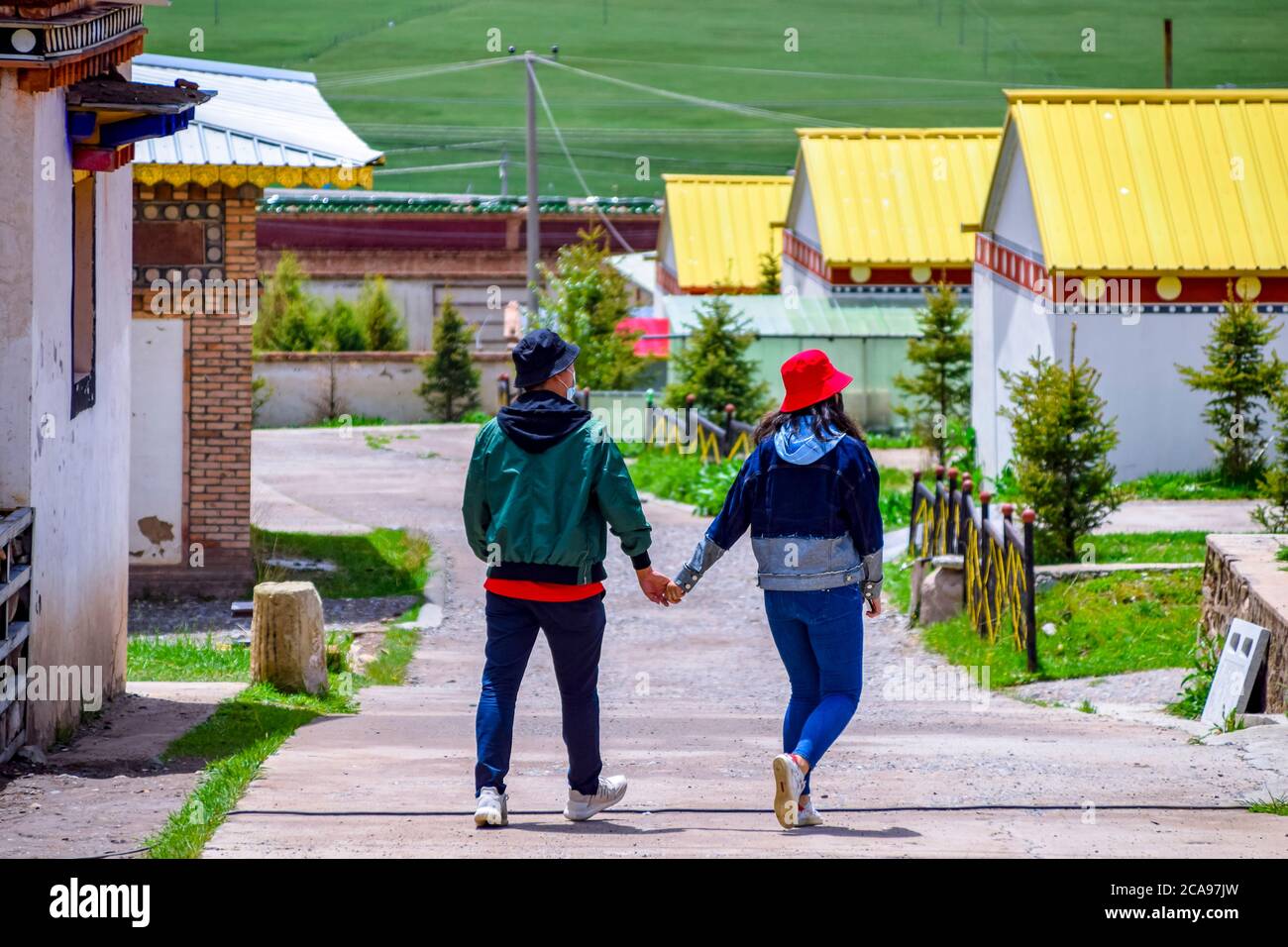 The couples walk in the Tibetan Buddhist monastery Arou Temple.A famous historic site in Qilian,Qinghai China. Stock Photo