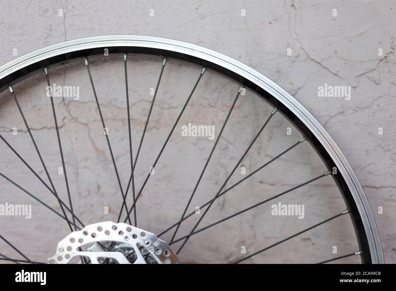 a double rim of a bicycle wheel without a tire, against a background of a textured eraser. Bicycle wheel repair, hub, bicycle iron rim Aluminum bicycl Stock Photo