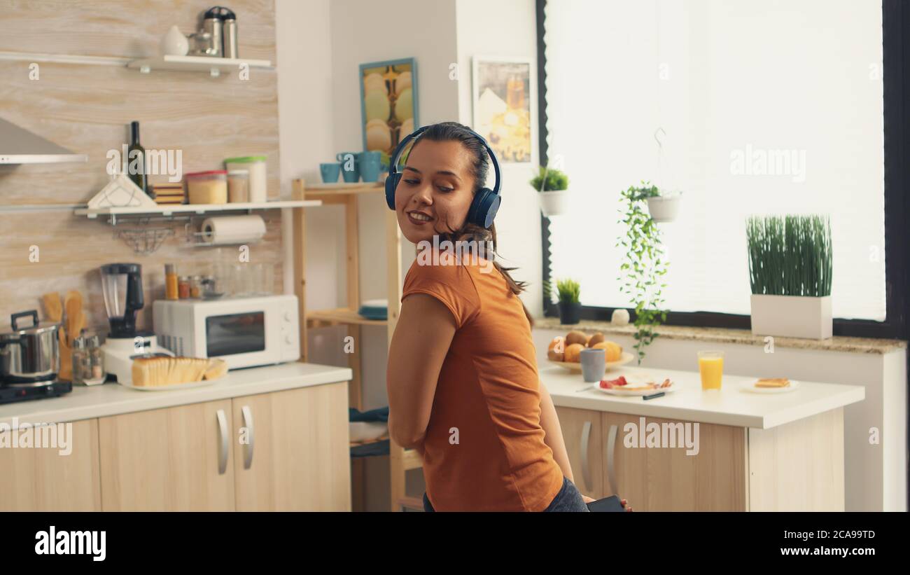 Funny young housewife cooking in kitchen Stock Photo - Alamy