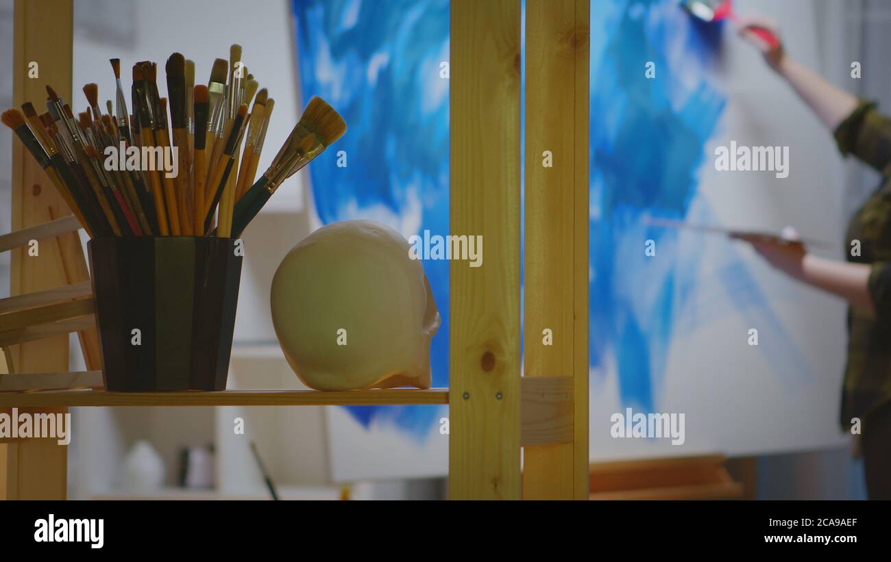 Young female artist in her studio painting a masterpiece Stock Photo ...