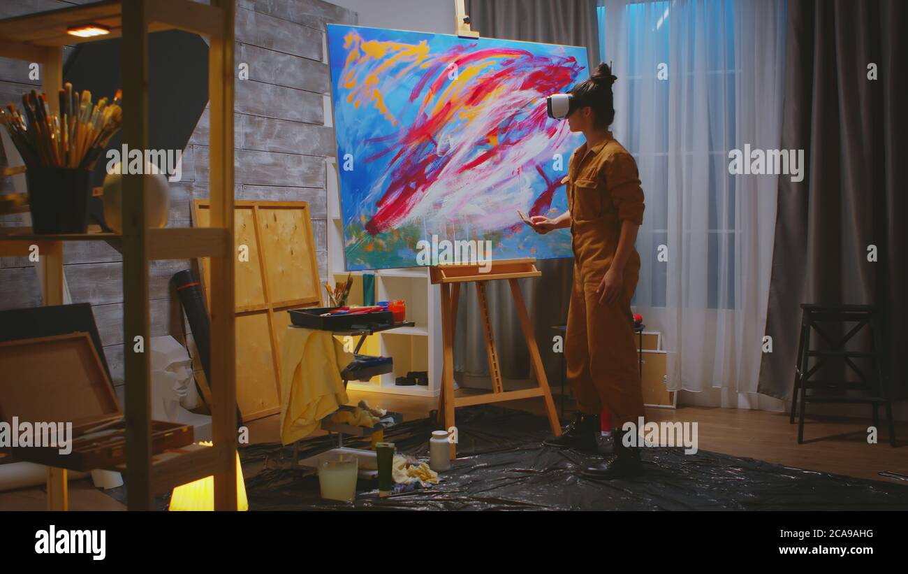 Female painter working on abstract painting in studio Stock Photo - Alamy