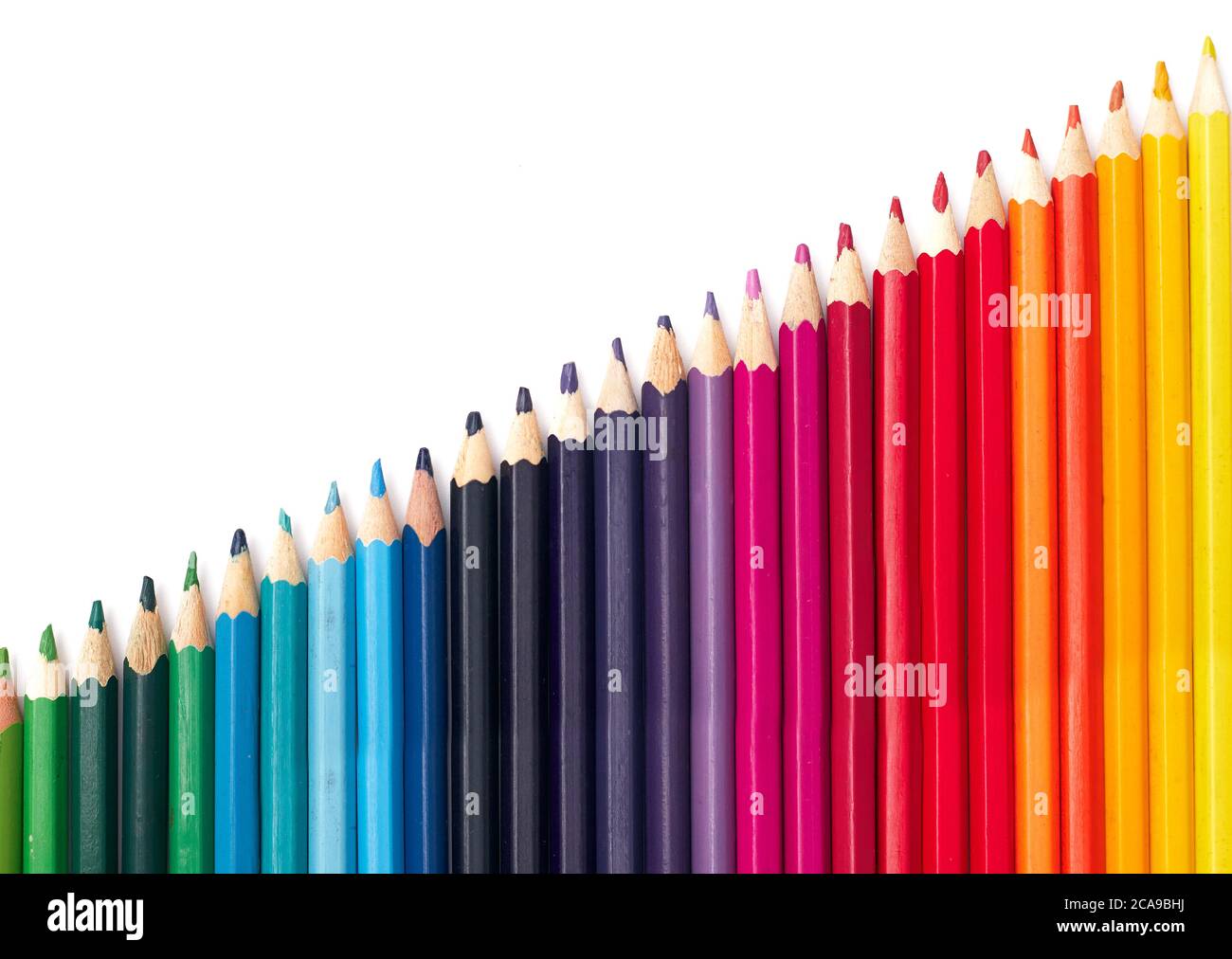 multicolored pencils in a row by color temperature on a white background isolate, flat lay Stock Photo