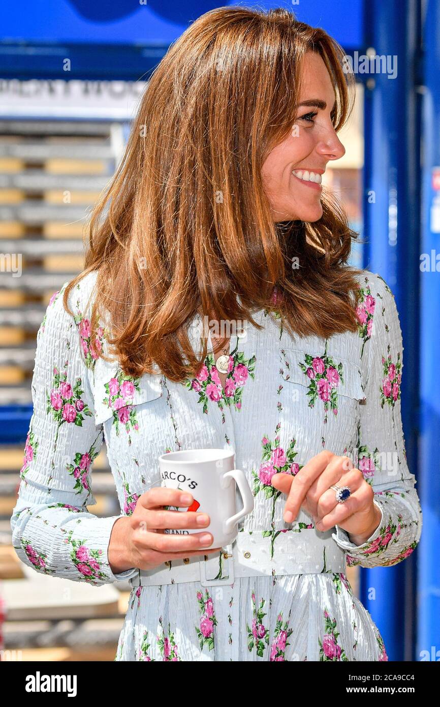 The Duchess of Cambridge holds a Marco's Cafe mug while chatting with business owners inside Marco's cafe, during the Duke and Duchess of Cambridge's visit to Barry Island, South Wales, to speak to local business owners about the impact of COVID-19 on the tourism sector. Stock Photo