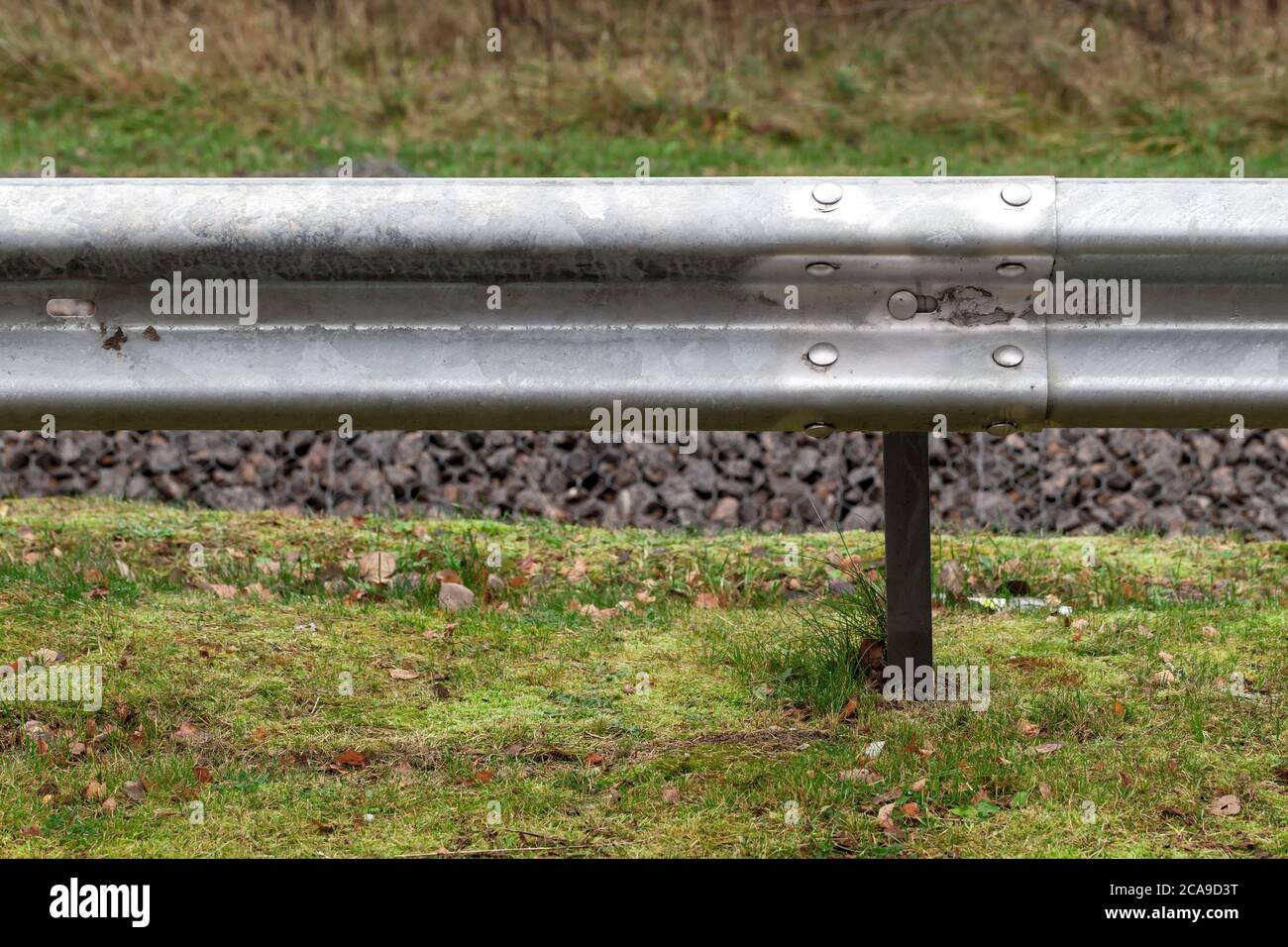 Metal guardrail mounted on a highway roadside Stock Photo