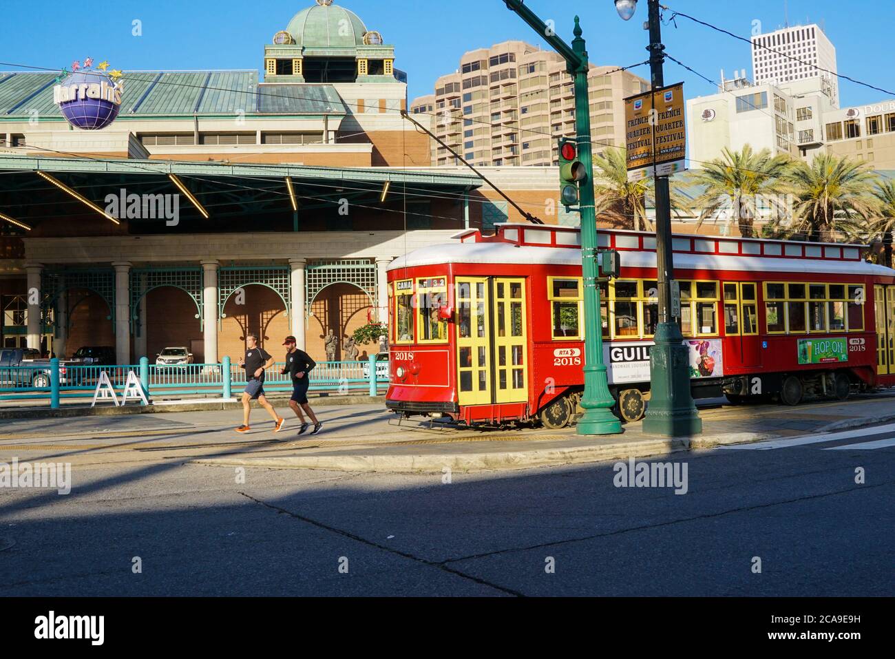 New Orleans - 04/15/2018 : runners and tram stop in front of Harrah's Casino, Canal Street Stock Photo