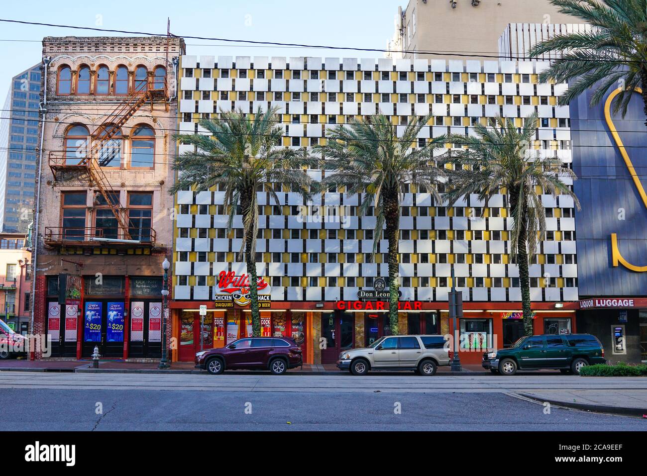 New Orleans - 04/15/2018 : Palms and buildings with different styles and eras Stock Photo