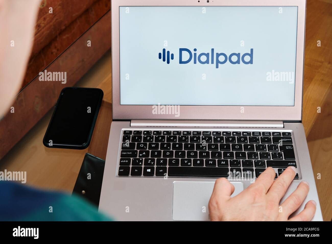 Dialpad is used for business meeting on laptop by man. An illustrative editorial image. San Francisco, US, June 2020. Stock Photo