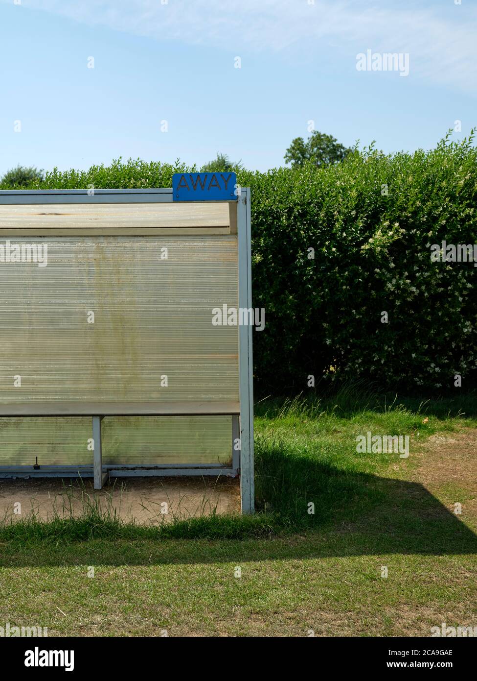 A sheltered sports field football dug out bench for the away team Stock