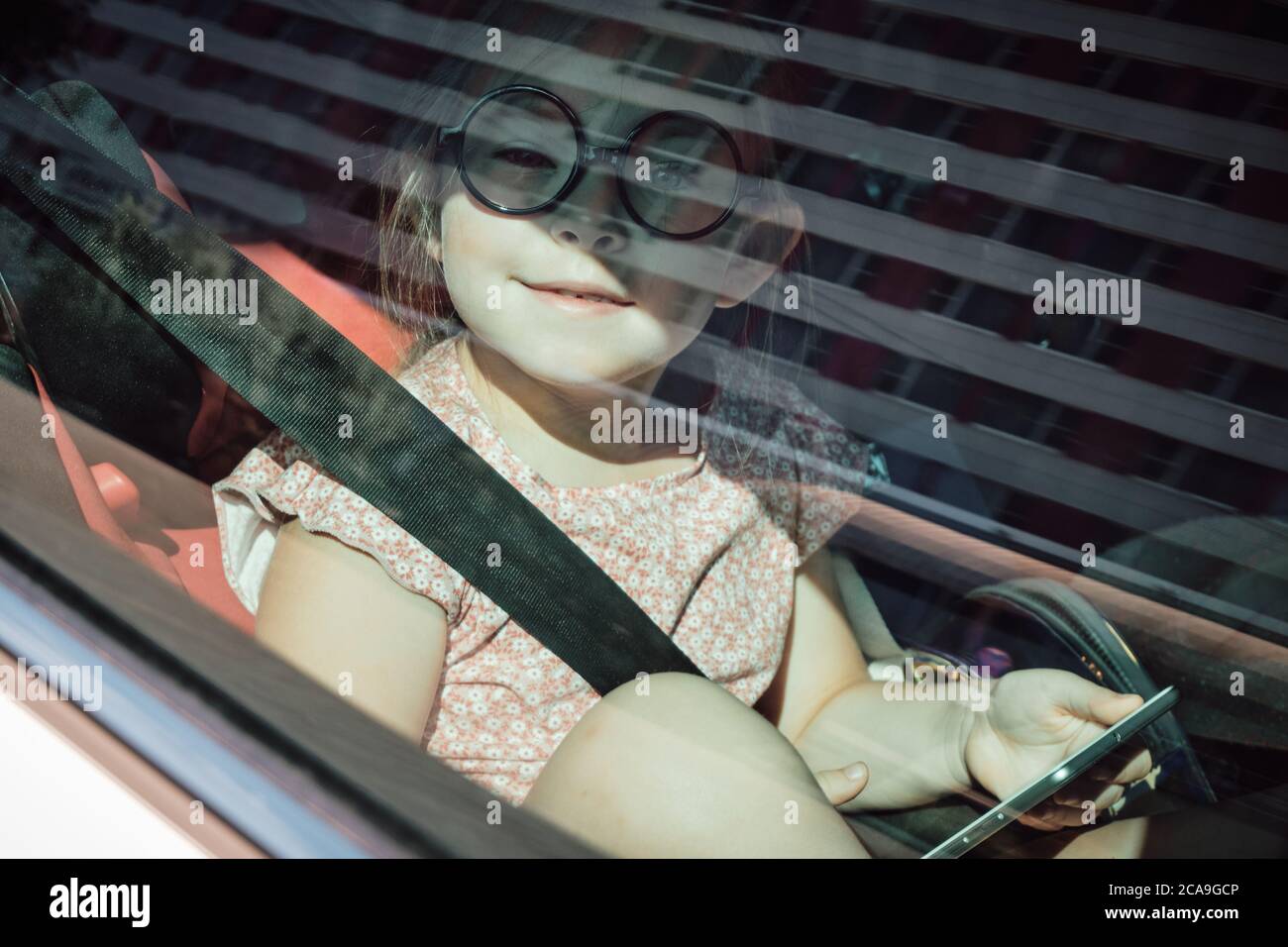 little girl sitting in the car. High quality photo Stock Photo