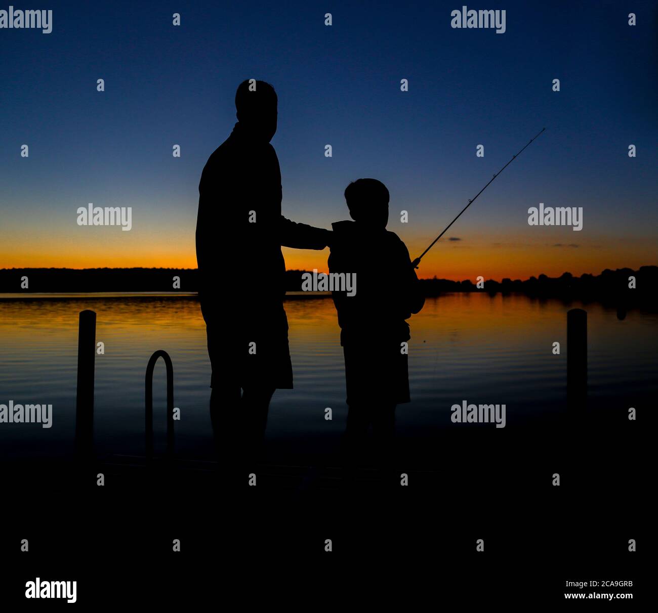 Silhouette of Father and Son Fishing Stock Photo - Alamy