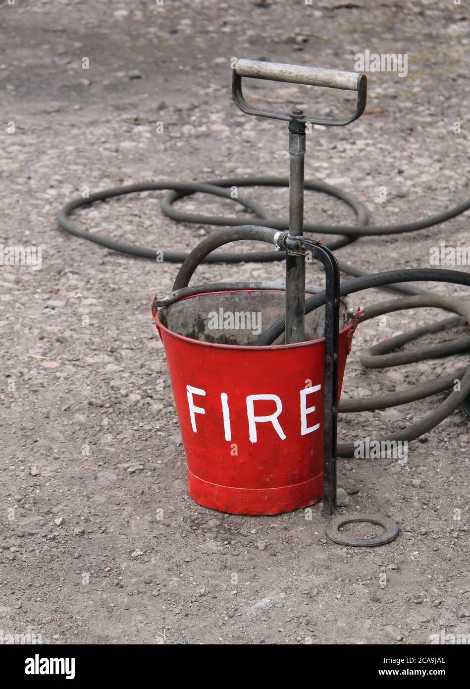 A Vintage Fire Bucket with a Hand Operated Pump Stock Photo Alamy