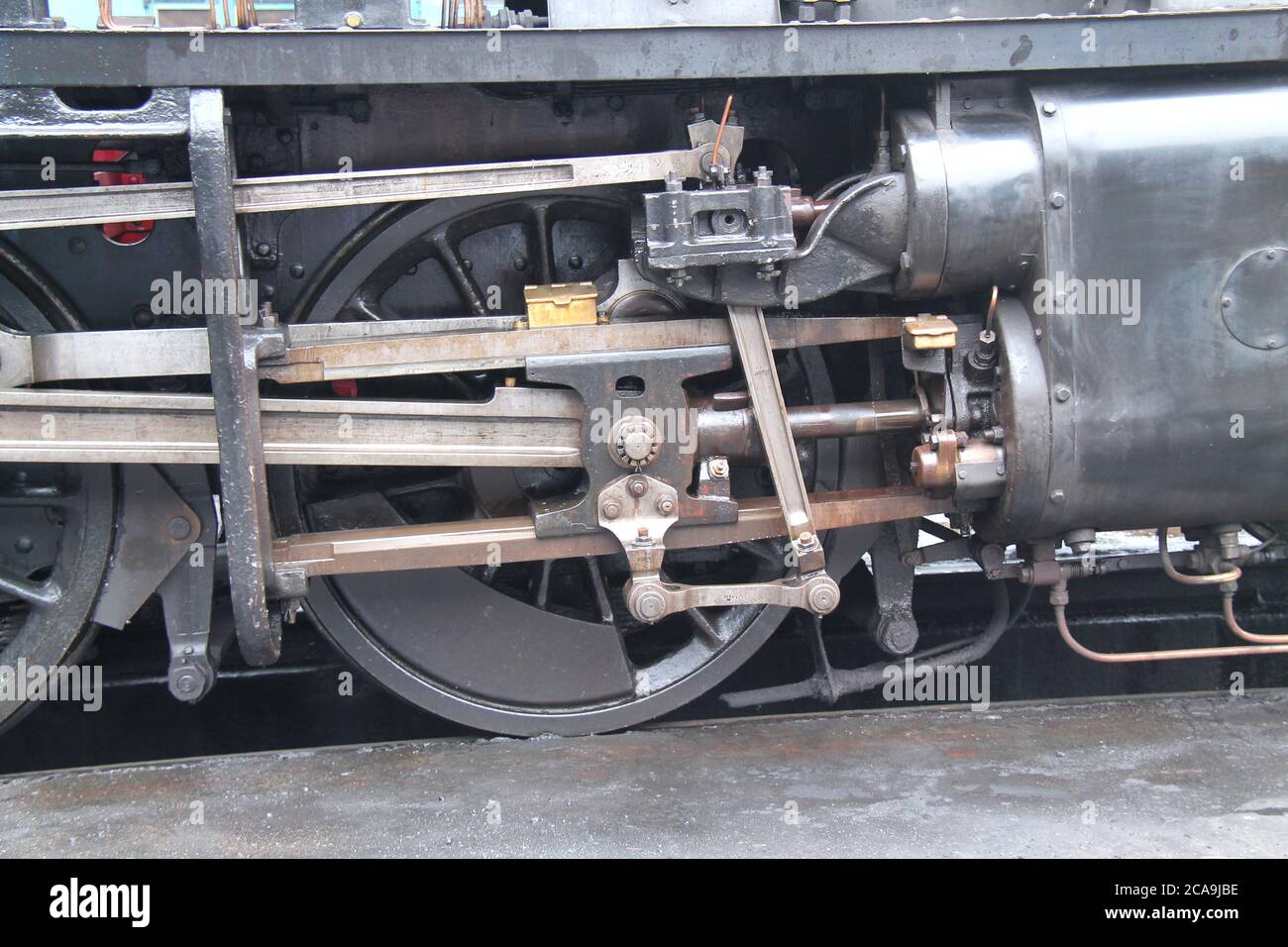 The Wheels and Drive Rods of a Steam Train Engine. Stock Photo