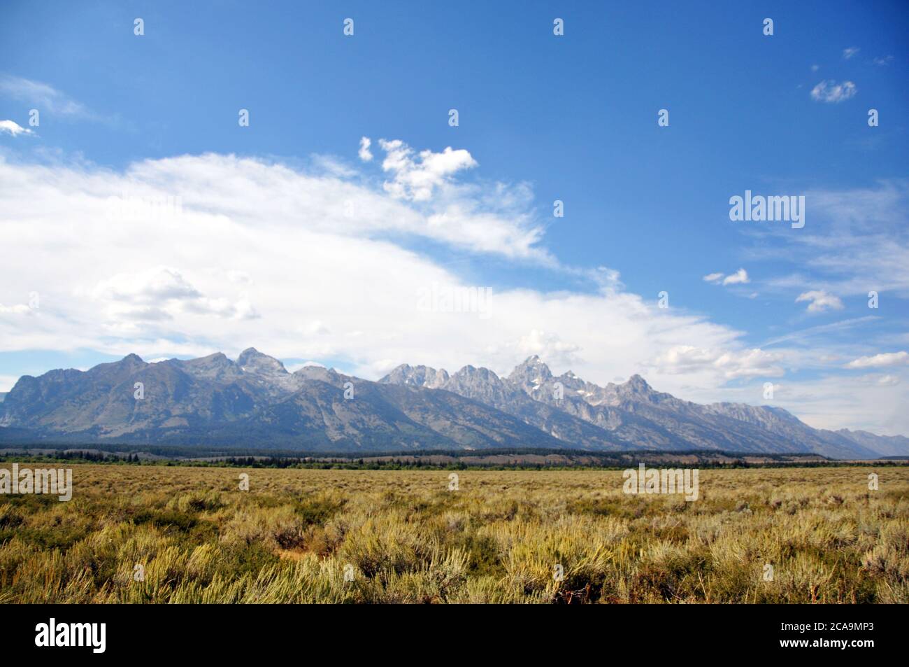 Peaceful mountain landscape with clear blue sky and white clouds hi-res ...