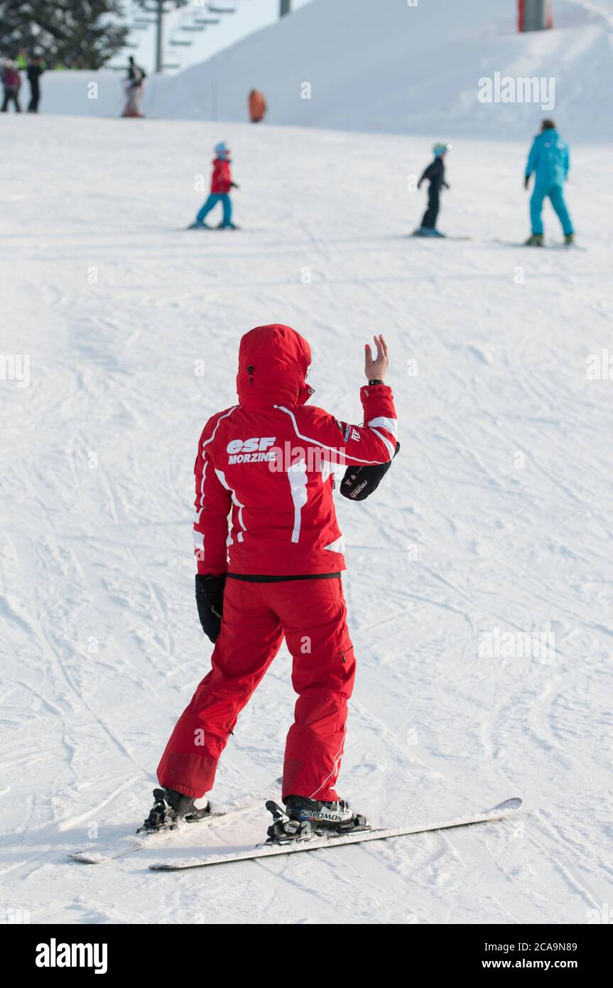 Learning to ski with ESF ski school on the slopes of the French ski resort of Morzine in the Haute-Savoie region of South Eastern France. Stock Photo