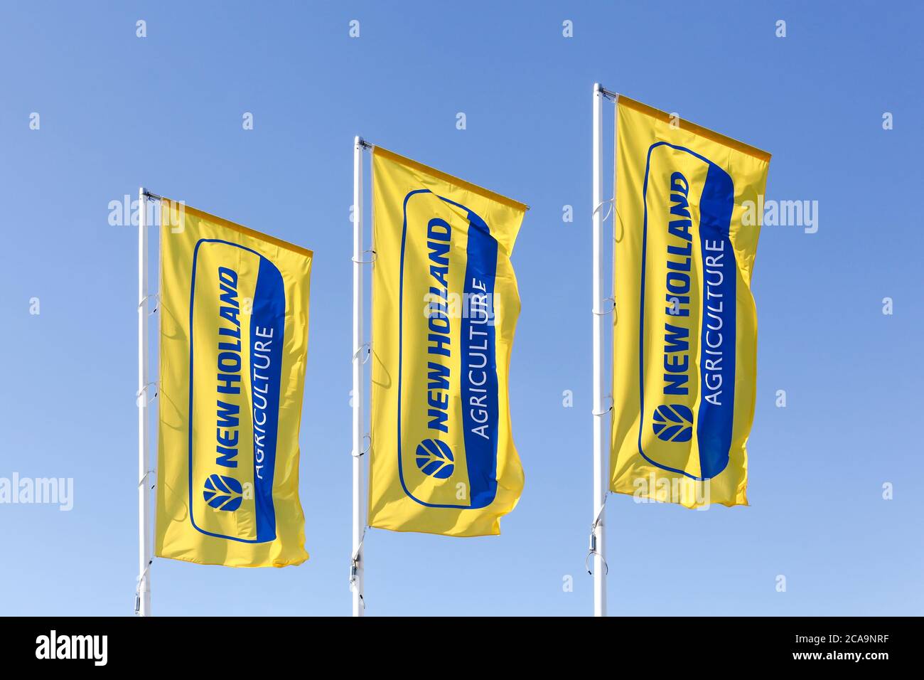 Autun, France - July 5, 2020: New Holland Agriculture flags. New Holland is a brand agricultural equipment manufactured by CNH Industrial Stock Photo