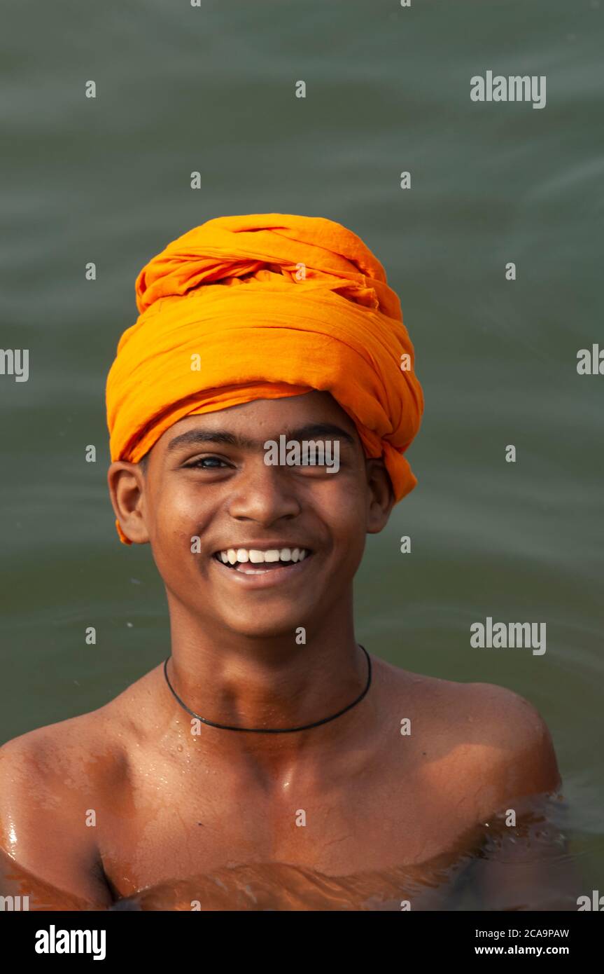 Young Smiling Sikh in the water at  the Golden Temple, Amritsar ,Punjab, India Stock Photo