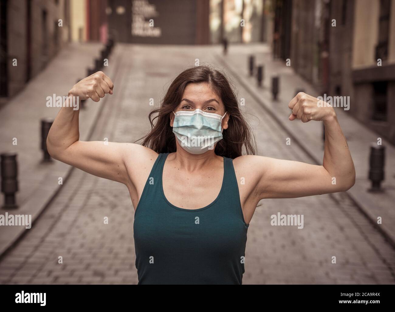 Young woman wearing surgical mask on face in public spaces. Coronavirus spreading protection mask protective against influenza viruses and diseases. P Stock Photo