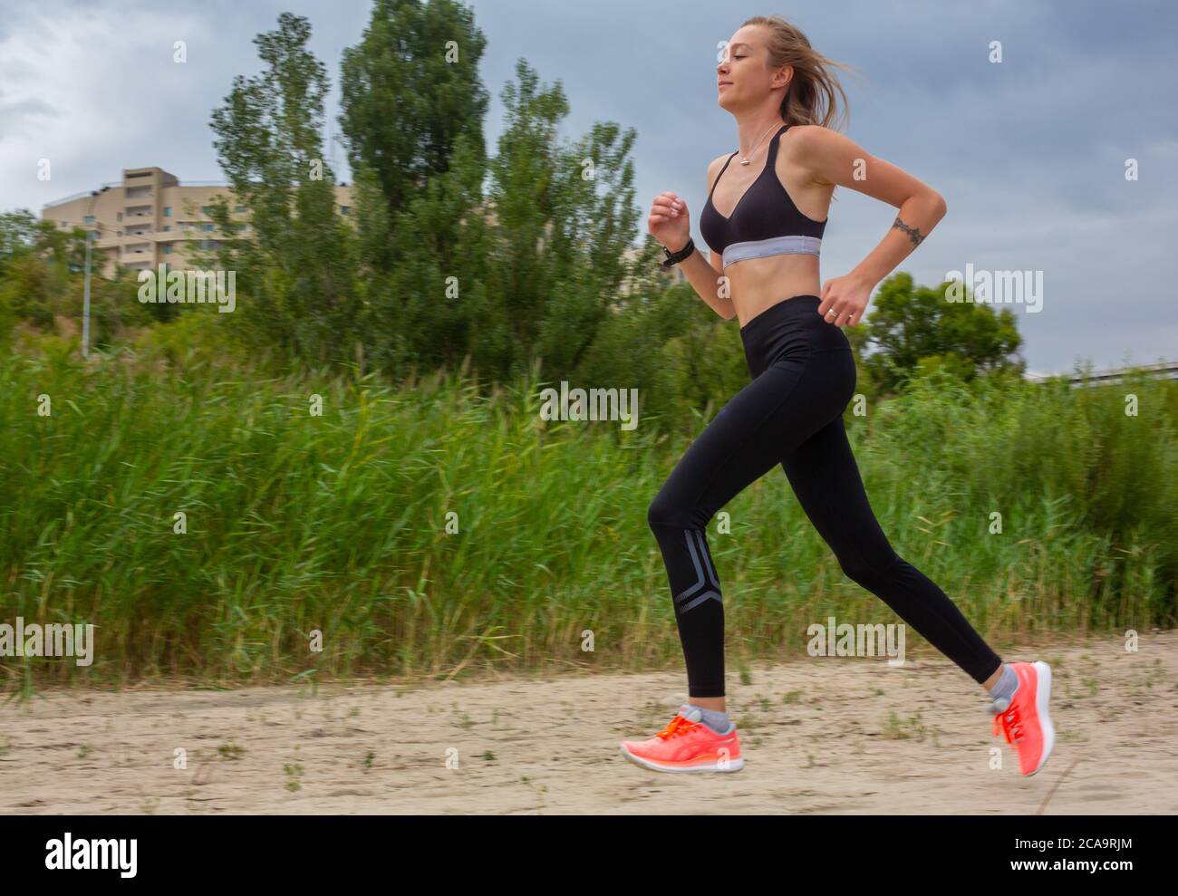 Runnuing Outside View Running in city park. Woman runner outside jogging, mountain view in ...