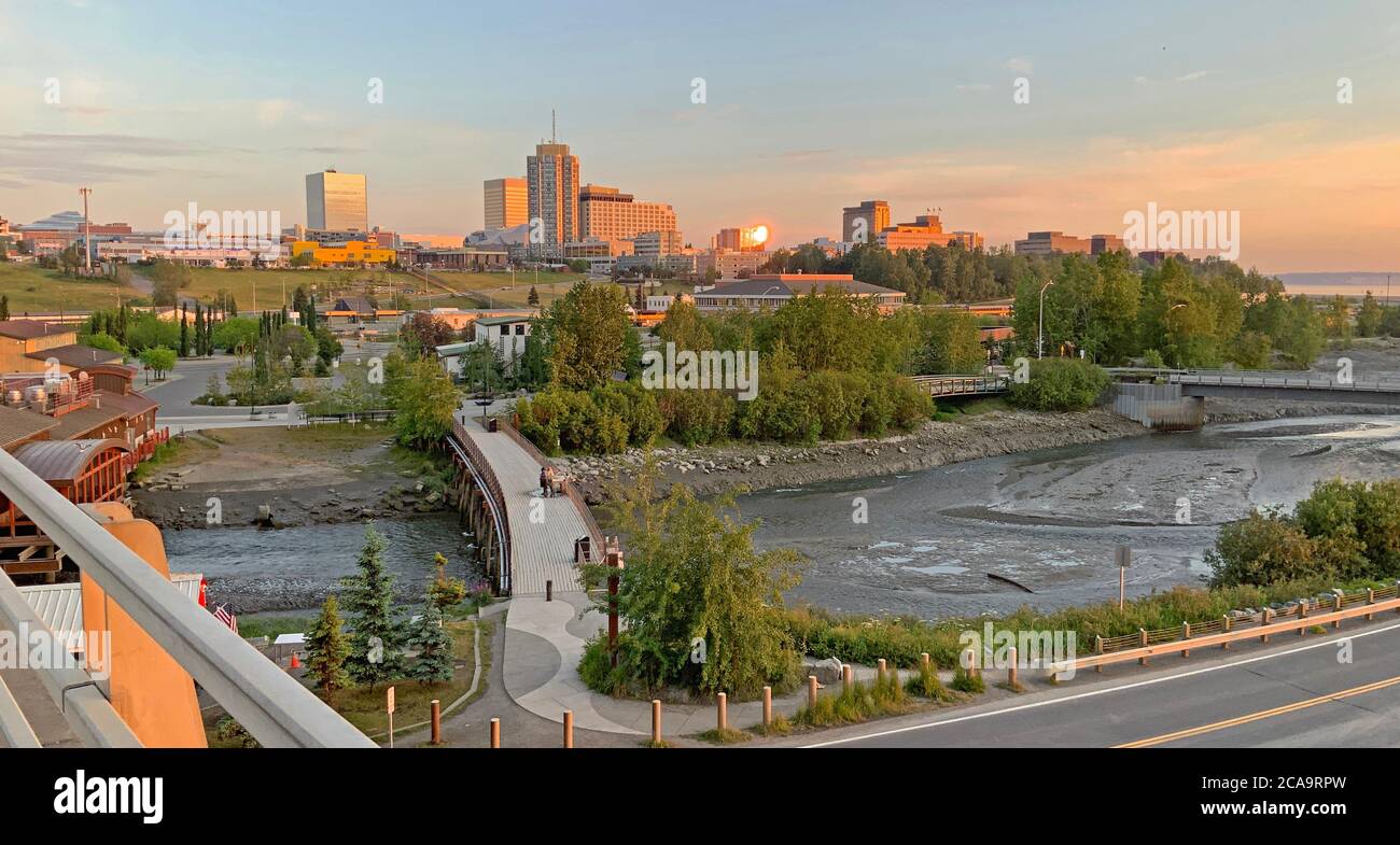 Downtown Anchorage all aglow at midnight with Fish Creek Stock Photo