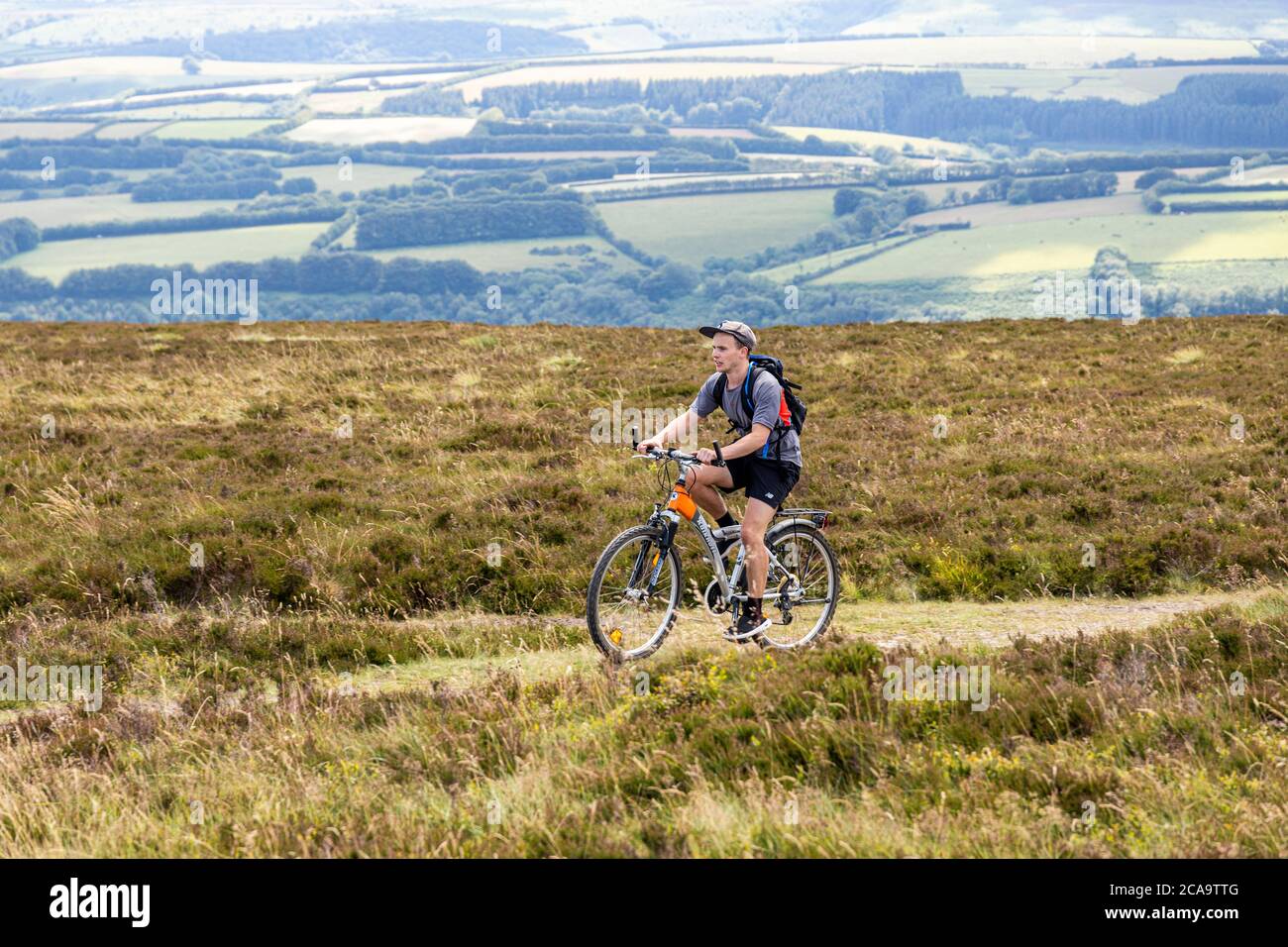 Exmoor National Park - A mountain biker about to arrive at the highest point of Exmoor, Dunkery Beacon 1705 feet 520 metres, Somerset UK Stock Photo