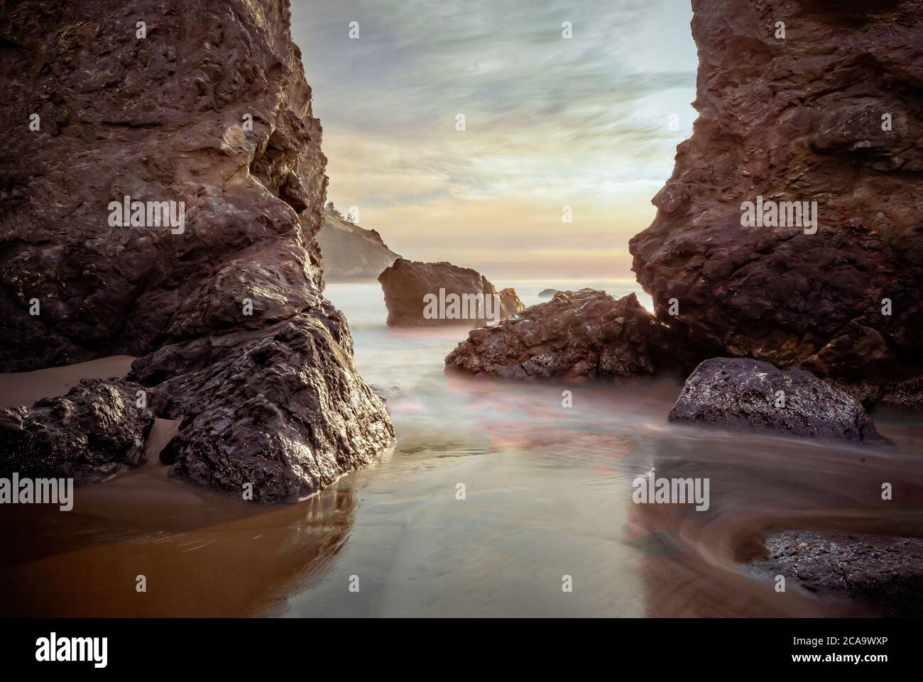 Rocks in the pacific ocean at sunset, California. Long exposure Stock ...