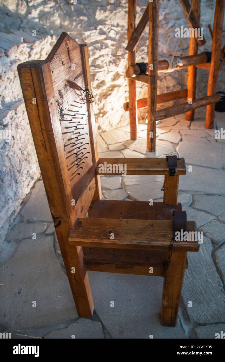 Spišské Podhradie Slovakia July 31, 2020 Wooden chair medieval torture with nails in the back, and seat. Prison of the Spissky hrad, Szepes vár. Stock Photo