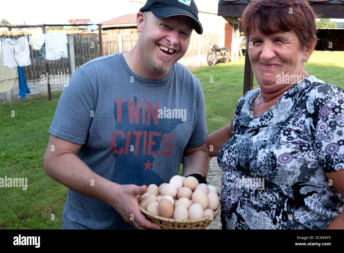 Man holding a basket of fresh eggs purchased from a local Polish farmer. Zawady Gmina Rzeczyca Poland Stock Photo