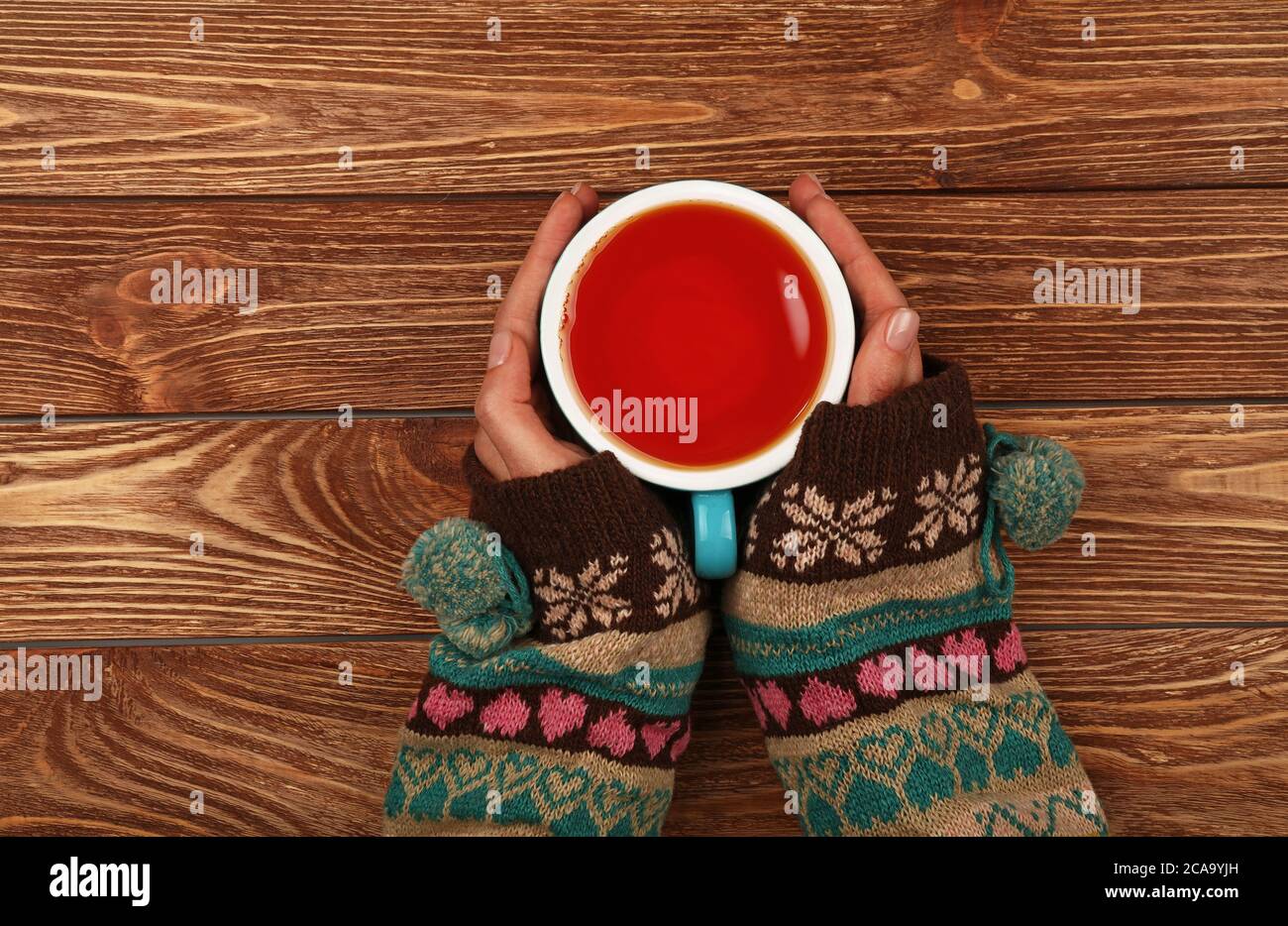 Hand Over Tea Close up two woman hands hold and hug big full cup of black tea or red ...