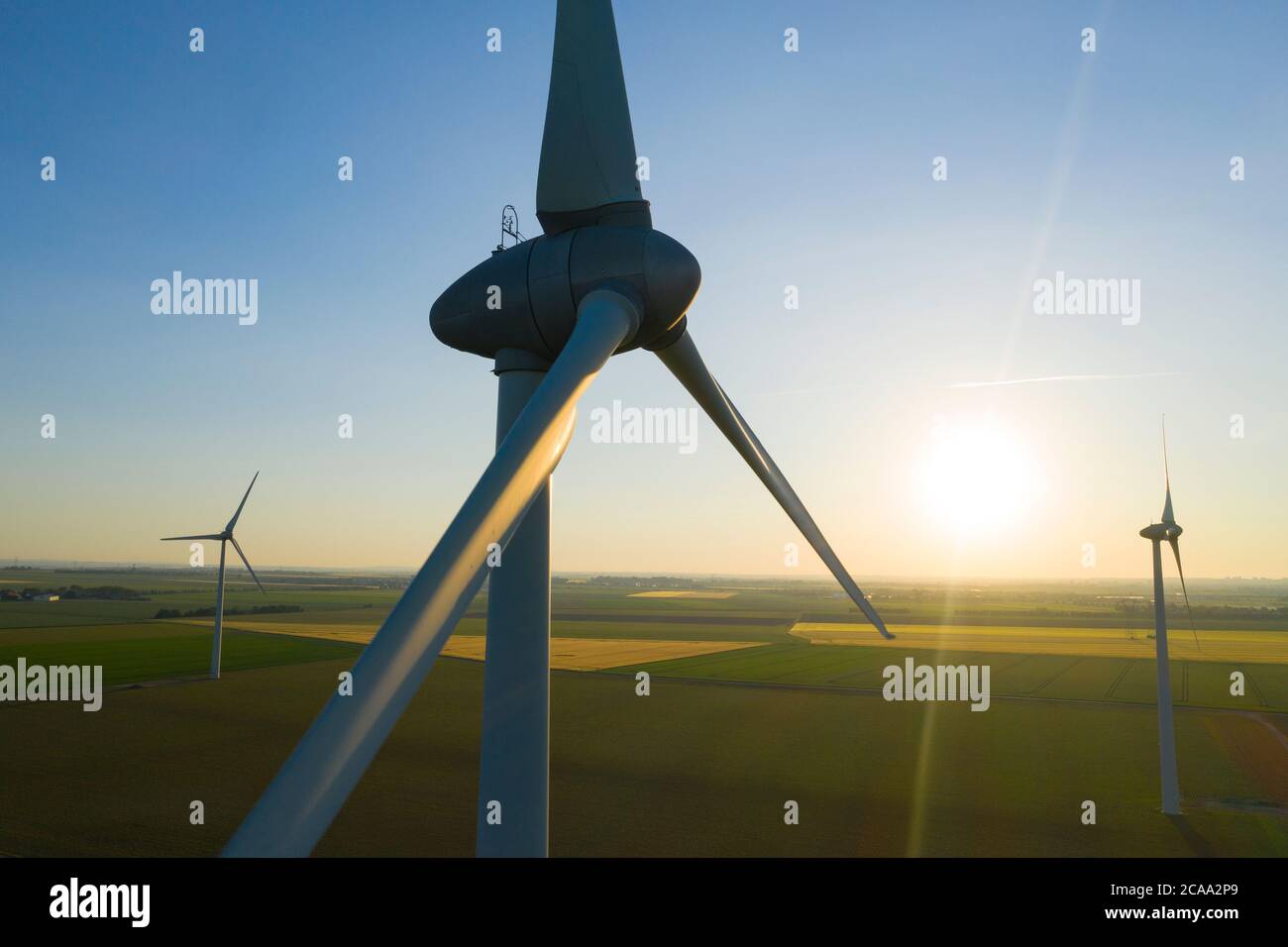 Aerial view of Wind turbines Energy Production - aerial shot on sunset Stock Photo