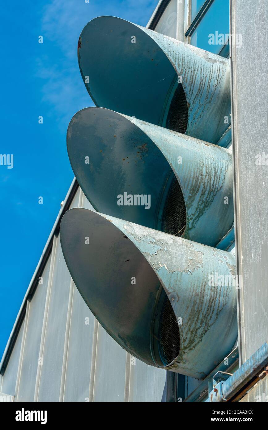 Three metal pipes of an industrial aeration on the putside of a factory Stock Photo