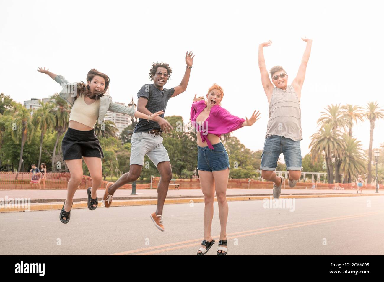 A group of friends being happy and jumping in the city Stock Photo - Alamy