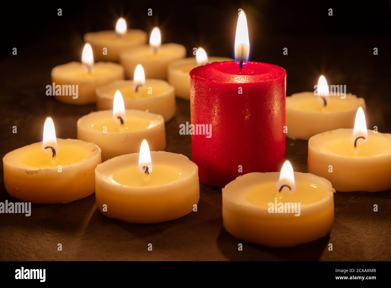 The odd one - Playing with different colored candles. Selective focus Stock Photo