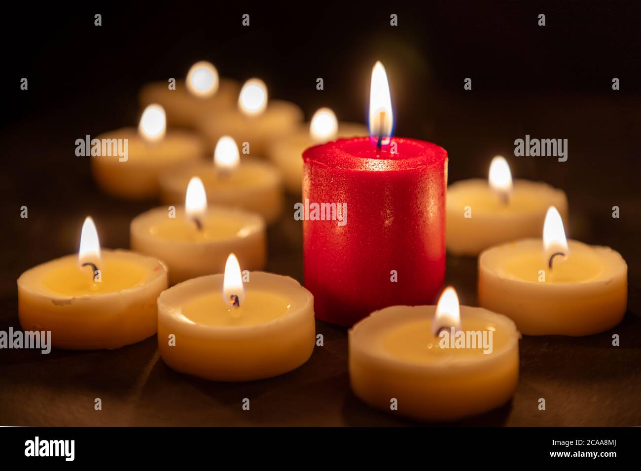 The odd one - Playing with different colored candles Stock Photo