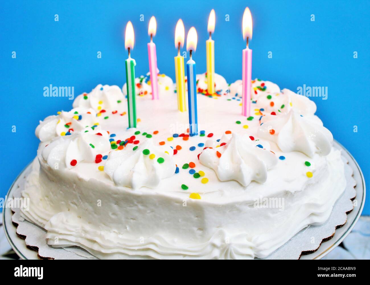 Birthday cake with lit candles Stock Photo Alamy
