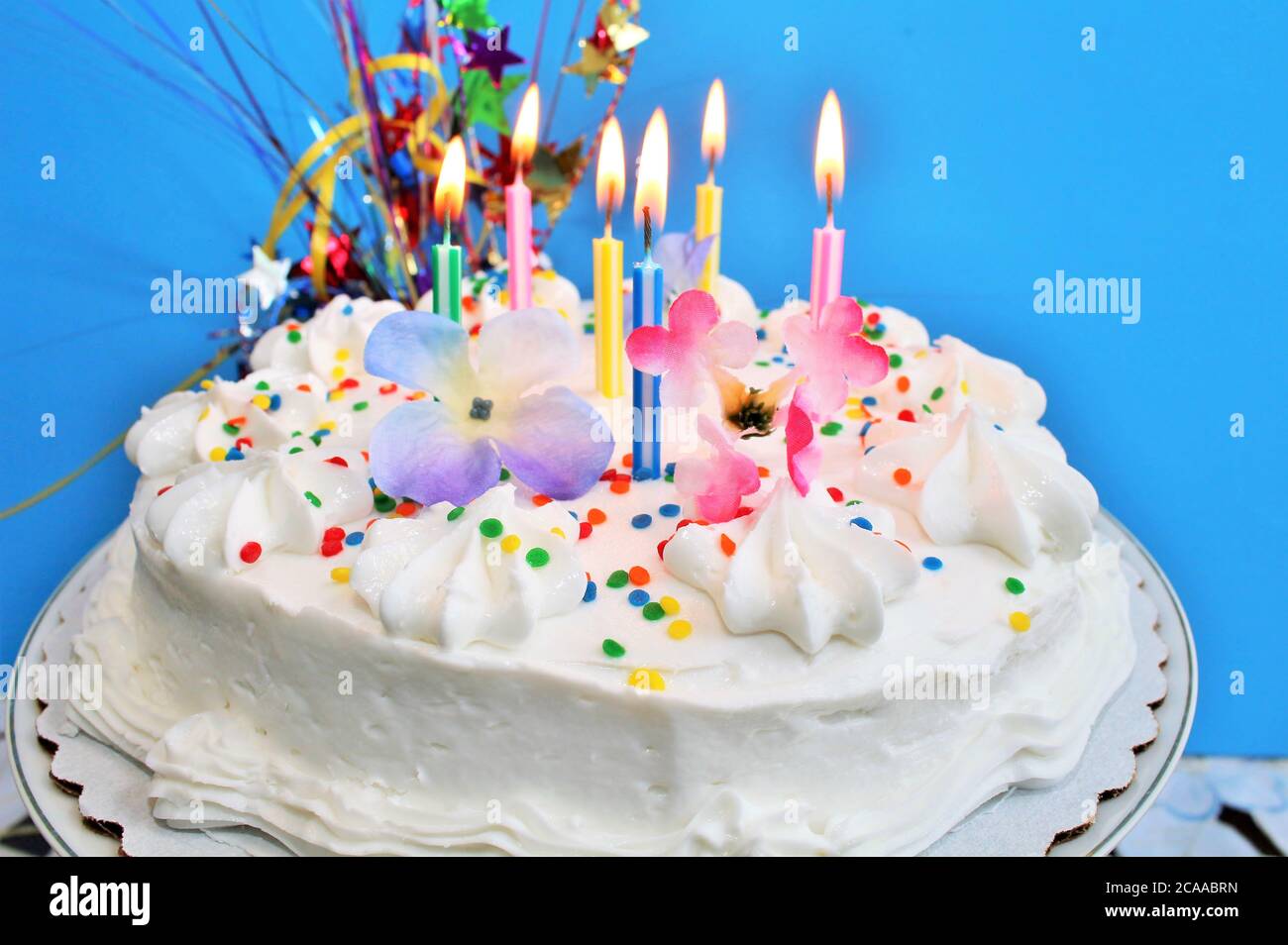 Birthday cake with lit candles Stock Photo - Alamy