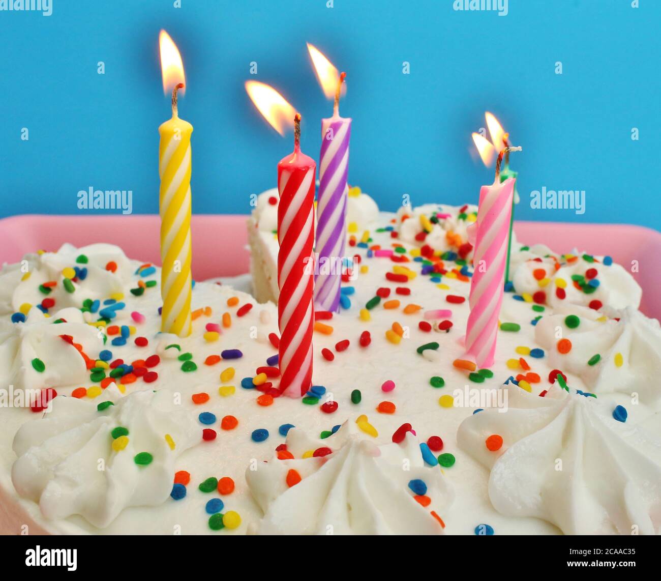 Birthday cake with lit candles Stock Photo - Alamy