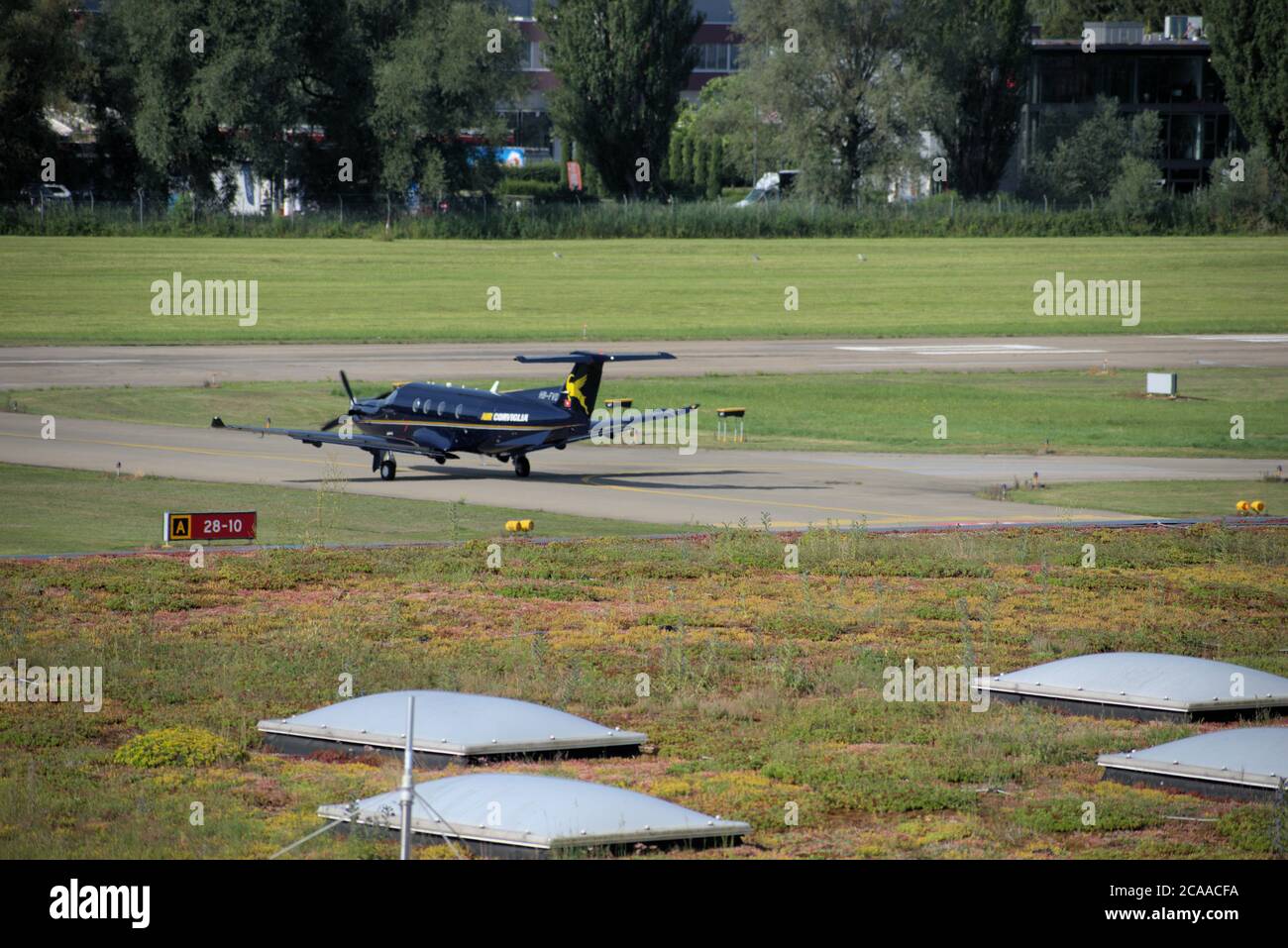 Pilatus PC-12 is taxiing at the airport Saint Gallen Altenrhein in Switzerland Stock Photo