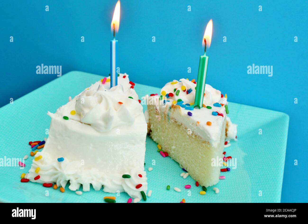 Birthday cake slices with candles Stock Photo Alamy