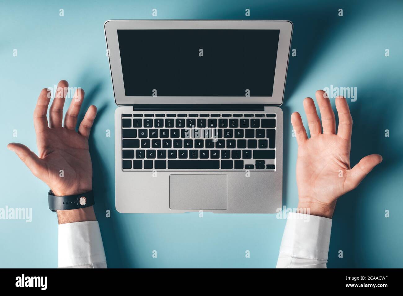 Frustrated laptop computer user, top view mock up copy space. Hands spread in disbelief and frustration. Stock Photo