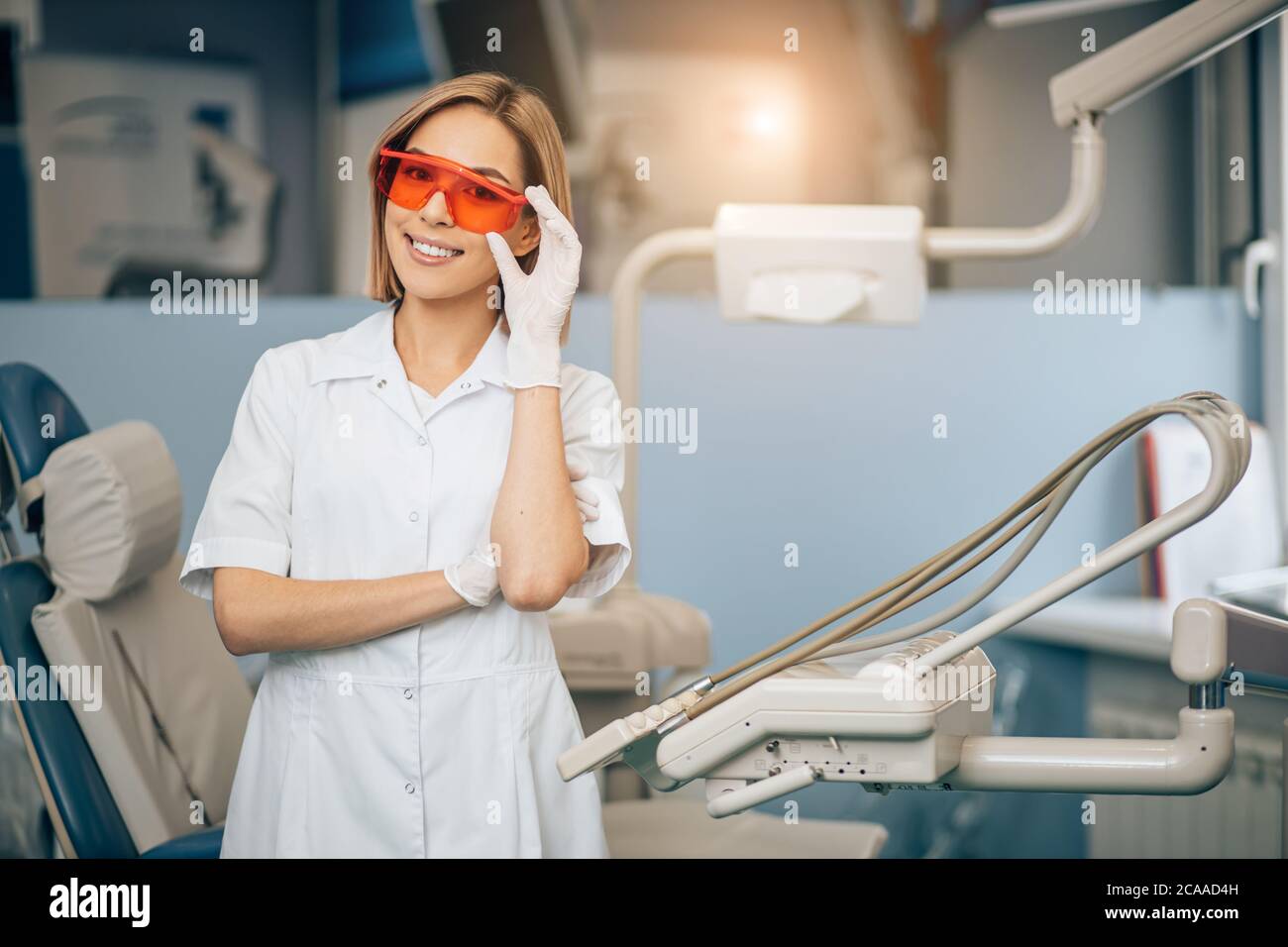 attractive goodlooking woman working as dentist in clinic wearing