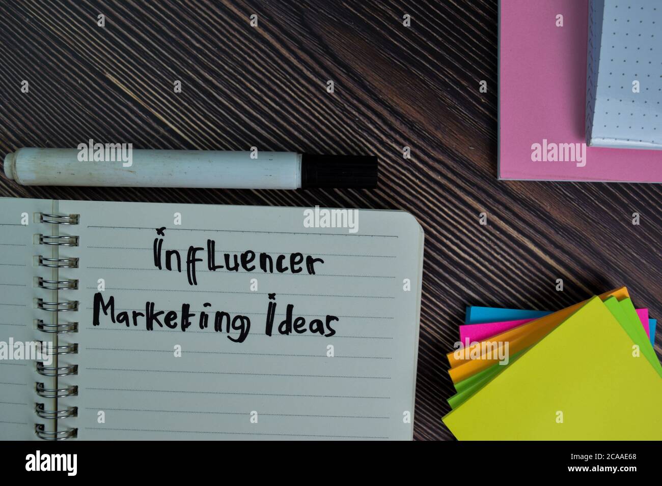 Influencer Marketing Ideas Write On A Book Isolated Wooden Table Stock influencer-marketing-ideas-write-on-a-book-isolated-wooden-table-stock