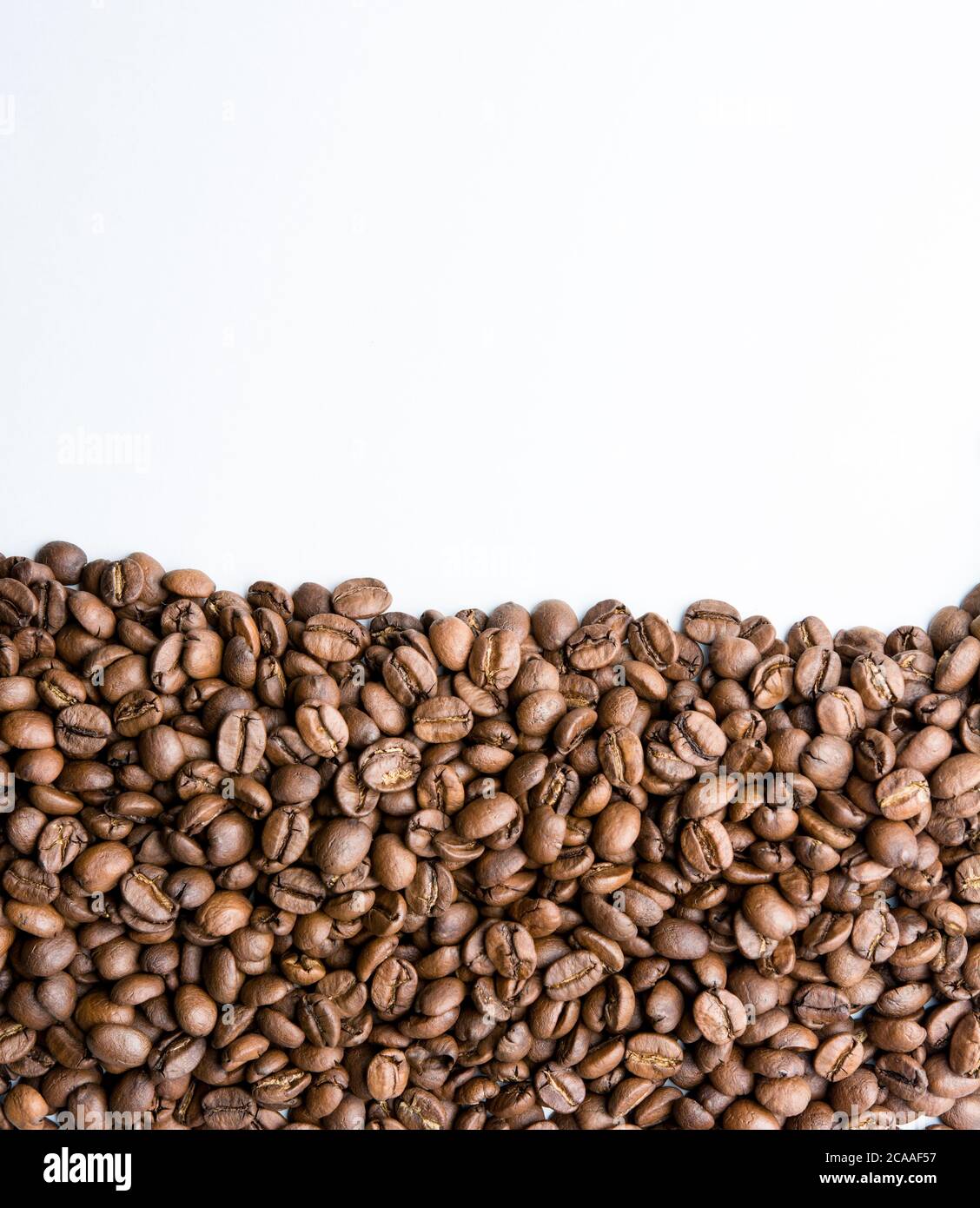 Roasted coffee beans pile isolated on white background Stock Photo - Alamy