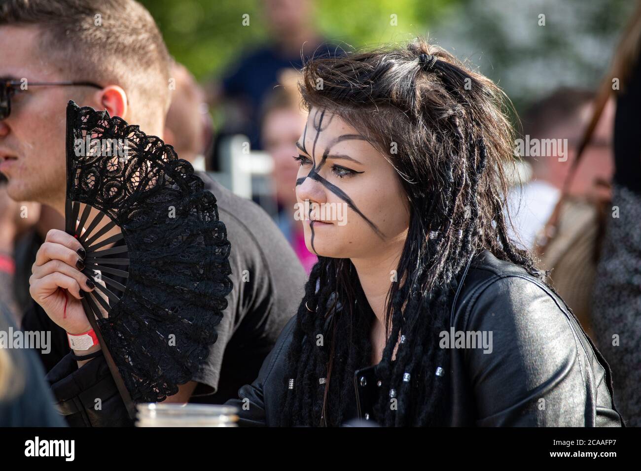 Young goth woman with face painting and folding hand fan Stock Photo