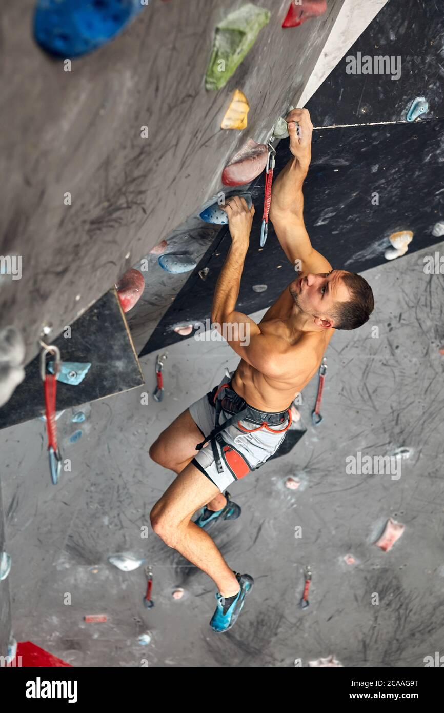 Athletic male climber instructor posses basic belay skills, feeling