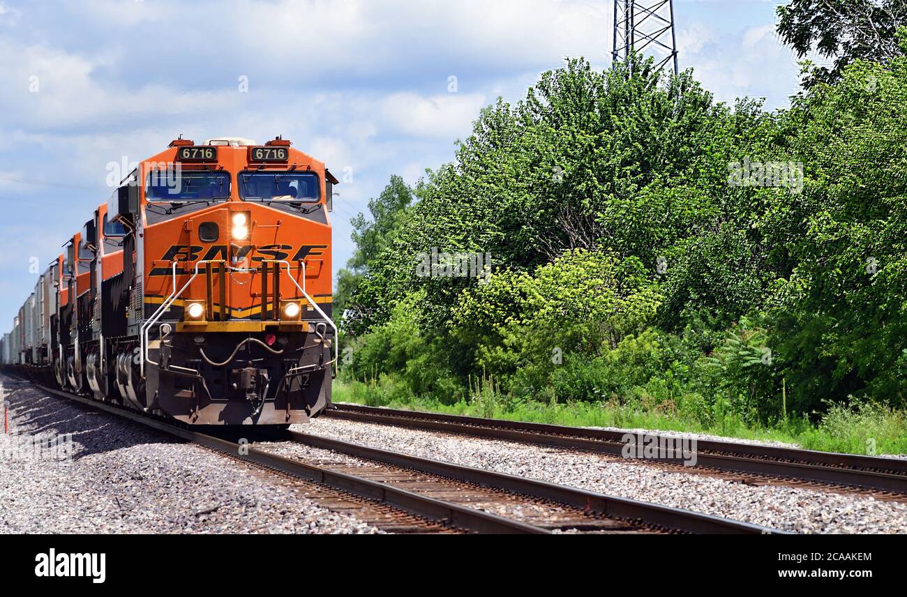 Mazon, Illinois, USA. A Burlington Northern Santa Fe stack train roaring through Mazon, Illinois on a sunny summer day. Stock Photo