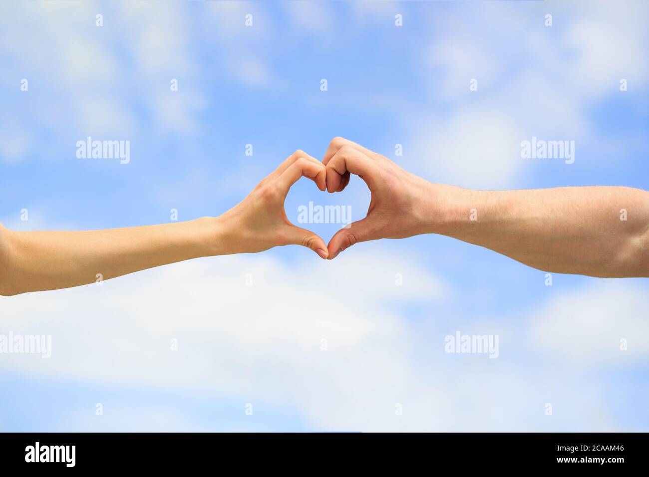 Love, friendship concept. Girl and male hand in heart form love blue ...