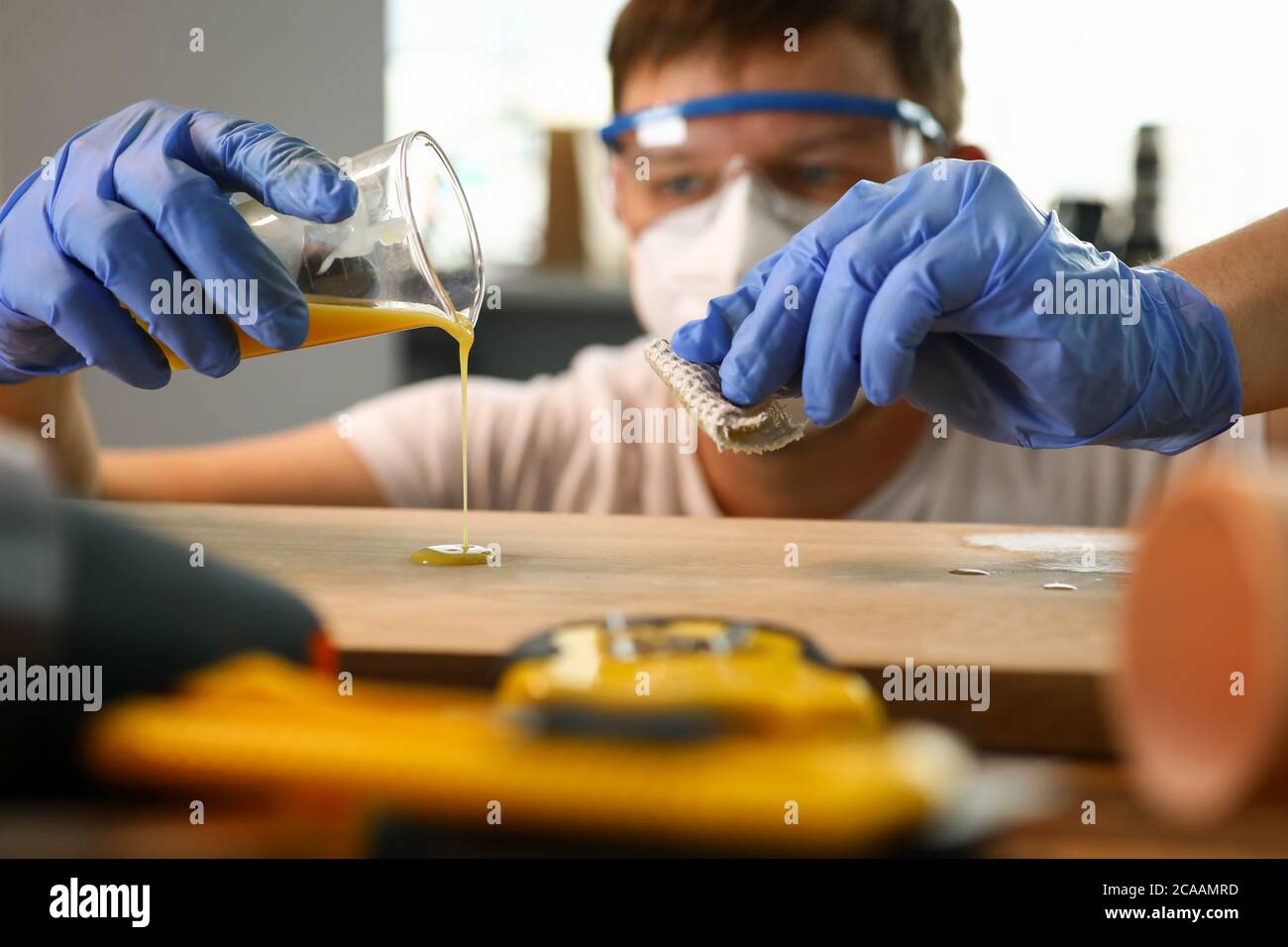 Woodworker varnishing furniture Stock Photo