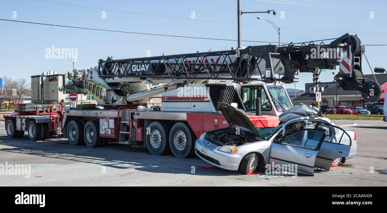 Car hit by crane on street Stock Photo
